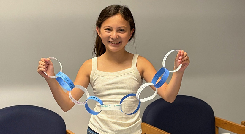 Student holding a paper chain.