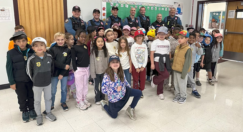 Students standing with police officers.