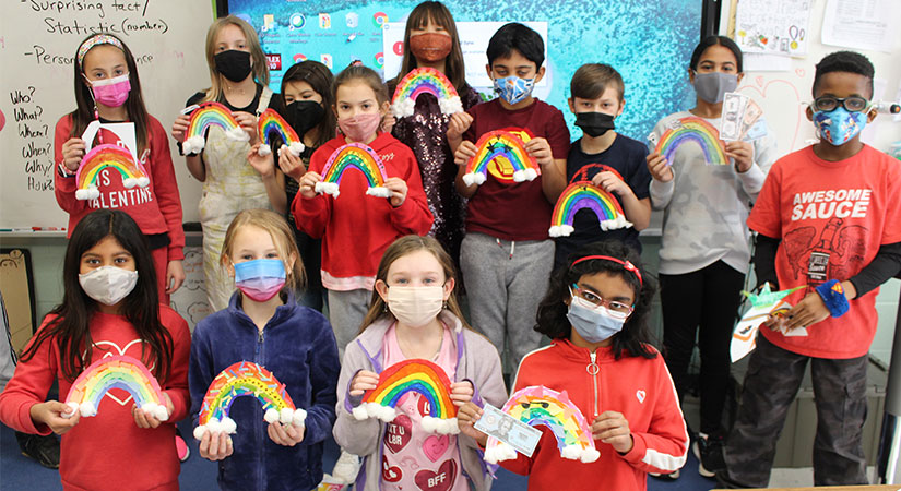 Students holding rainbows.