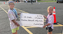 Students holding a check for St. Jude's