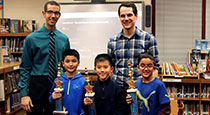 Students holding trophies