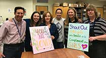 A group of teachers holding signs