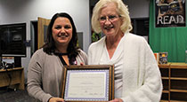 Two women holding up a certificate.