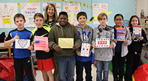 Students holding tank you cards.