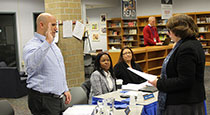 Board member being sworn in.