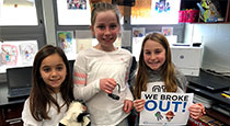 Students holding a breakout sign.