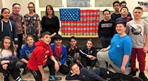 Students next to cans decorated as an American flag.