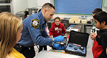 Police officer working with students.