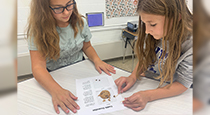 Student conducting an activity with a cookie.