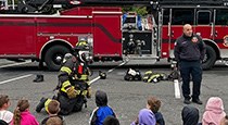 Students in front of fire truck.