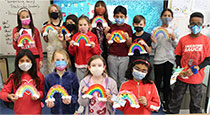 Students holding rainbows.