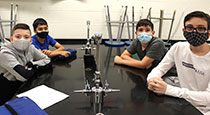 Students at a science desk.