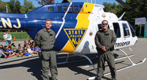 Police standing in front of a helicopter