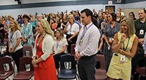 Faculty in conference room standing.