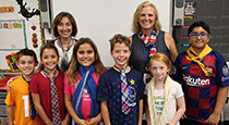 Students standing in front of a white board.