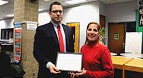 Mary Russo receiving a certificate from board president David Brezee 