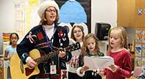 Teacher and students singing Christmas songs.