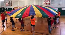 Students playing with a parachute