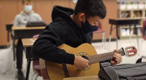 Student playing the guitar.