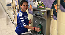 Student filling up a water bottle.